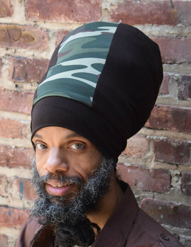 Man with locs wearing a brown stretch hat with a camouflage panel at the front. The hat is available in different lengths from 10" to 20".