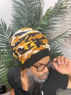 Right View - Man wearing a yellow camouflage stretch hat. The hat has a round flat top and available in different lengths from 10" to 20".