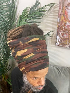 Man wearing a dark camouflage turban with an open top. Available in different lengths from 10" to 18".