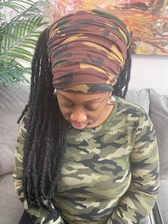 Front view - Woman wearing a dark camouflage turban with an open top. Available in different lengths from 10" to 18".